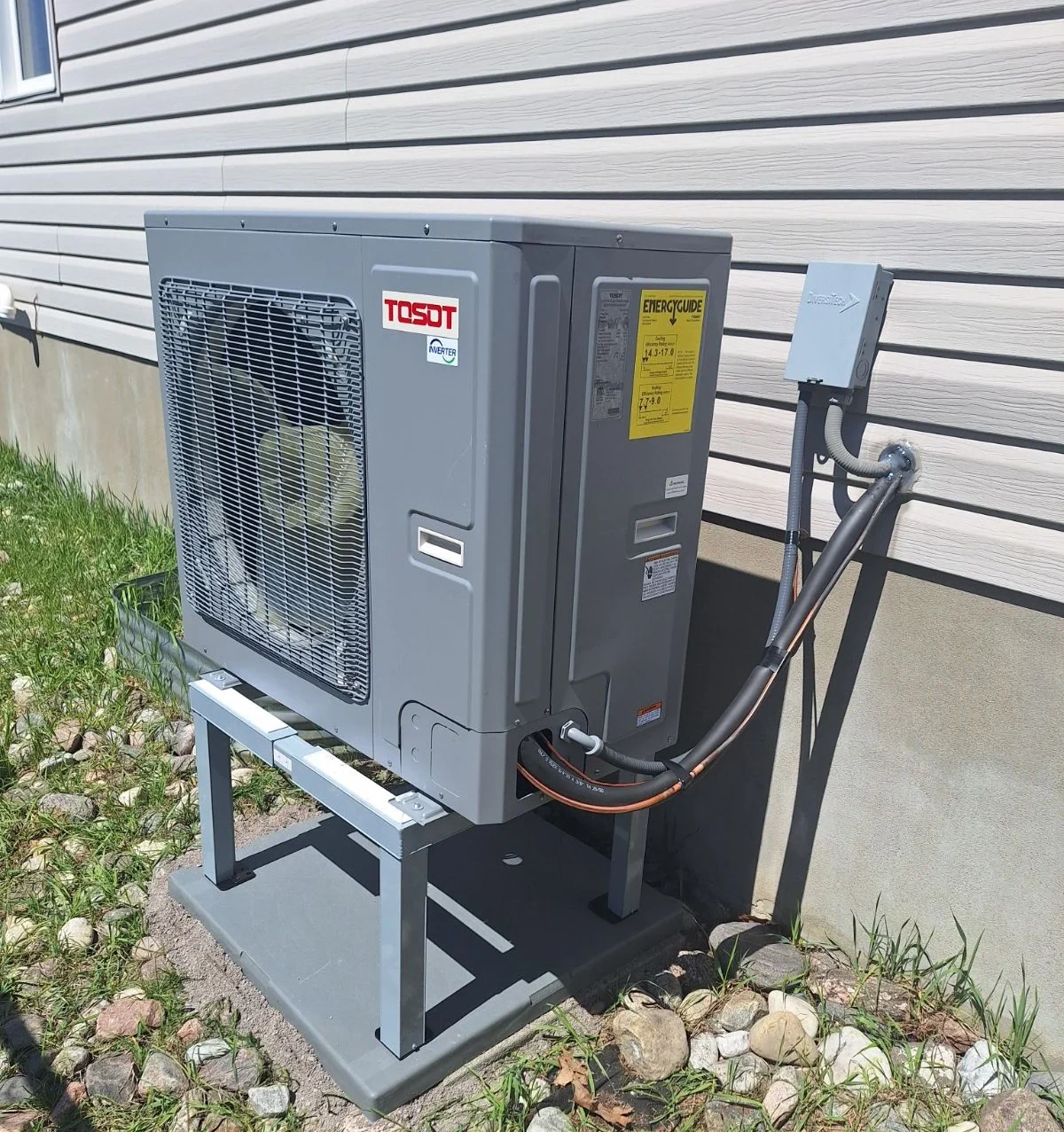Licensed installer fitting a cold-climate heat pump